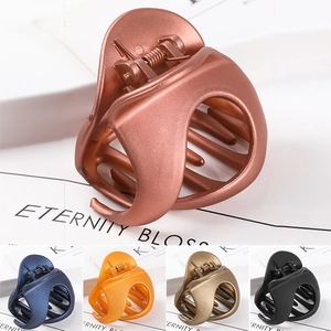 Detail showing multi-color selection of matte large hollow hair claws in various shades