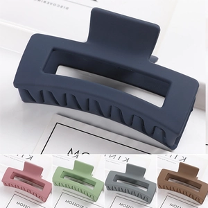 Detailed view of large matte rectangular hair claws in various vibrant pastel colors