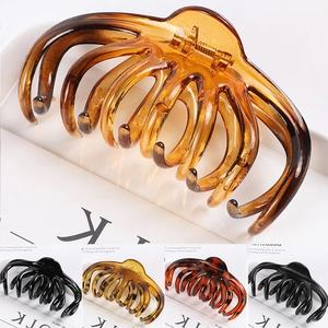 Detail view of large resin hair claws in amber, black, and leopard print patterns