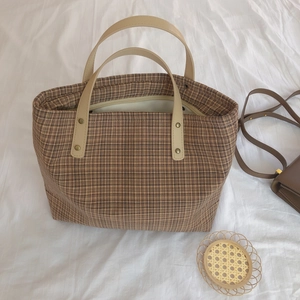 Vintage brown plaid tote bag with faux leather handles shown from a top-down view