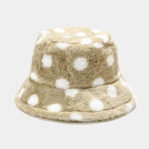 Detailed view of the thick plush texture and white polka dot pattern on the bucket hat