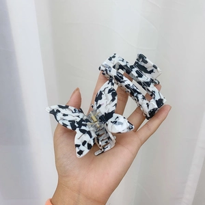 Detail of cow pattern acetate hair claw set featuring butterfly and rectangle shapes