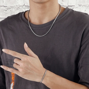 Men's minimalist stainless steel box chain necklace and bracelet set on a model