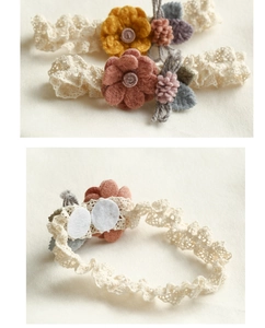 Detail of baby lace headband featuring soft felt flowers and comfortable inner lining