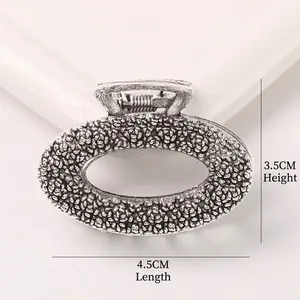Detail view of a vintage silver alloy hair claw clip with grainy texture, size 4.5x3.5cm