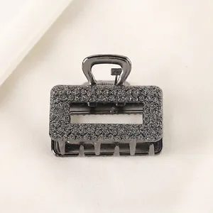 Detail of gunmetal alloy hair claw clip with embossed rose floral pattern textures