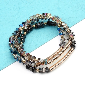 Detail of beaded bracelet with dark faceted crystals and hammered gold tube accents