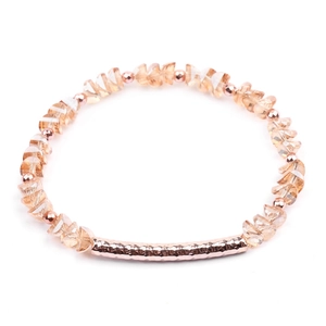 Detailed view of faceted champagne crystal beads with a hammered rose gold metal tube