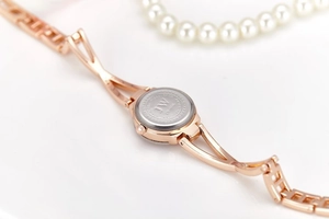 Detailed close-up of stainless steel watch back with JW logo and water resistant engraving