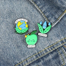 Detailed view of eco-friendly enamel pins set on denim fabric with SAVE WATER text