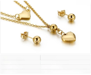 Detailed view of golden stainless steel heart jewelry set with necklace and stud earrings