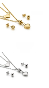 Detail of layered heart pendant necklace and matching ball stud earrings set in gold and silver