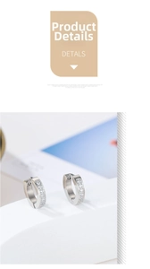 Detail view of silver stainless steel hoop earrings with sparkling white cubic zirconia