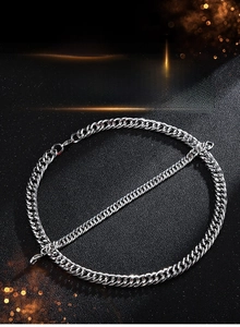 Close-up of polished silver stainless steel chunky Cuban chain necklace and bracelet set