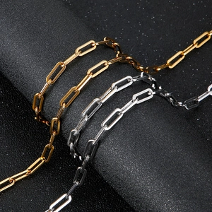Gold and silver stainless steel paperclip chain necklace set on black background