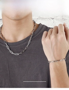 Detailed view of men's stainless steel rectangle link chain necklace and bracelet set