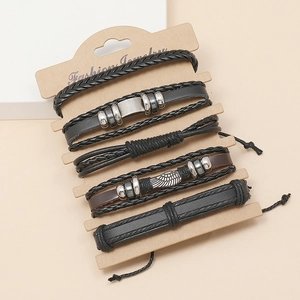 Detail view of 5-piece leather bracelet set with wing charms on jewelry card