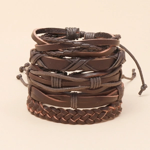 Close-up of stacked brown braided leather bracelets in various woven and layered designs