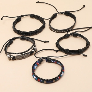 Detailed view of 5-piece set featuring black braided leather bracelets with feather charms