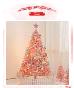 Pink flocked Christmas tree with warm LED lights, silver bows, and white picket fence