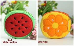 Detail of plush fruit coin purses featuring watermelon and orange designs with zippers