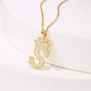 Gold plated crown letter S pendant necklace with micro-paved cubic zirconia on white base