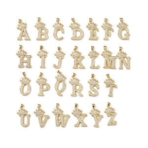 Set of 26 gold plated crown initial pendants with sparkling cubic zirconia on white background