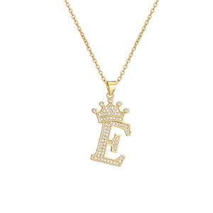 Macro shot of gold-plated letter E pendant with crown and shimmering zircon stones