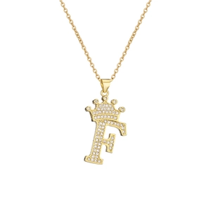 Macro detail of gold-plated crown letter F pendant with micro-set cubic zirconia