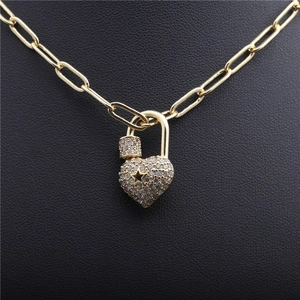 Hip hop heart lock necklace with clear zircon pavé star on a golden paperclip chain