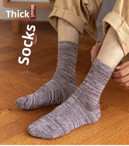 Detailed close-up of thick thermal crew socks with warm terry knit texture in grey