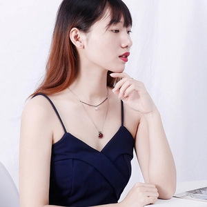 Double-layer stainless steel necklace featuring red round pendant and pearl accents