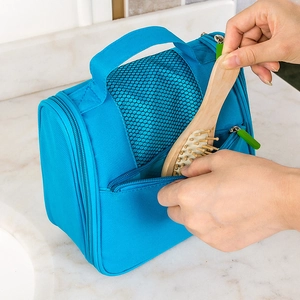 Large capacity bright blue travel toiletry bag with mesh window and sturdy handle