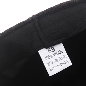 Men's wool flat cap interior showing high-quality 100% wool label and stitching