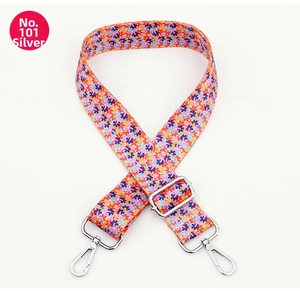 Close-up of a wide floral replacement bag strap with silver metal swivel hooks