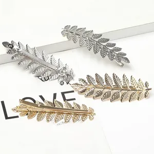 Detail of alloy leaf-shaped hair clips in gold and silver with spring claw structure