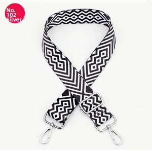 Detail of black and white geometric maze strap with silver metal swivel hooks