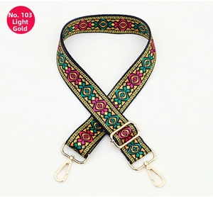 Detail of bohemian geometric jacquard bag strap with adjustable light gold metal hardware