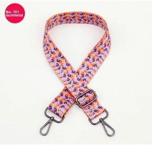 Detail of colorful floral polyester bag strap with gunmetal lobster clasps and slider