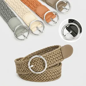 Close-up of woven elastic belts with silver round buckles in multiple colors for women