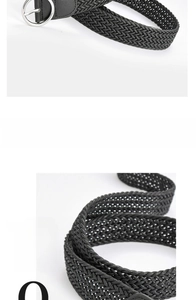 Close-up of black elastic woven belt with polished silver round metal buckle detail