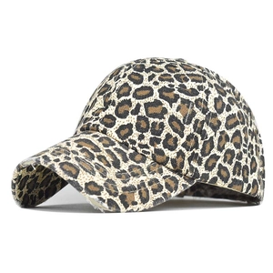 Close-up of leopard print baseball cap featuring distressed brim and cotton fabric texture