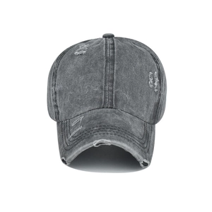 Detail of vintage washed dark grey baseball cap with distressed torn effects and texture
