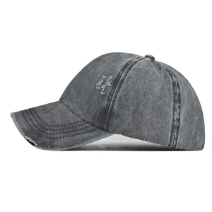 Close-up of distressed washed cotton baseball cap with vintage frayed edges and side profile