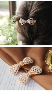 Detail of golden bow hair clip with white pearls and sparkling rhinestones for women