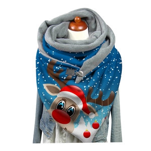 Detail of blue scarf with reindeer and snowflake patterns featuring a metallic ring buckle