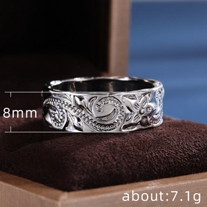 Detailed close-up of 8mm vintage engraved silver ring with embossed vine floral patterns