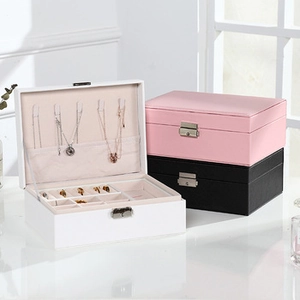 Detail of compact jewelry box with necklace hooks and ring slots in various colors