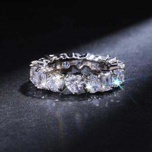 Macro detail of rectangle and heart-shaped cubic zirconia stones on silver band