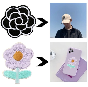 Close-up of colorful embroidered letter patches on baseball cap and mobile phone case